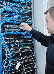 Image showing young it engeneer in datacenter server room