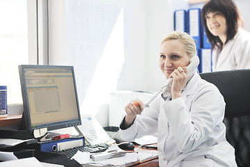 Image showing pharmacy worker talking by phone