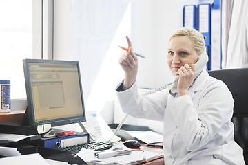 Image showing pharmacy worker talking by phone