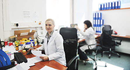 Image showing pharmacy worker talking by phone