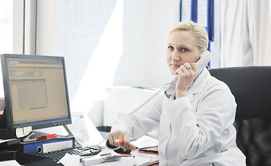 Image showing pharmacy worker talking by phone