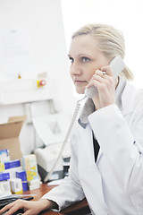 Image showing pharmacy worker talking by phone