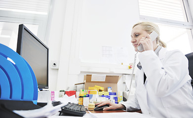 Image showing pharmacy worker talking by phone