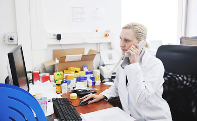 Image showing pharmacy worker talking by phone