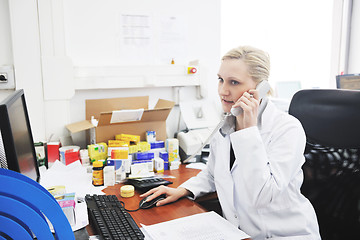 Image showing pharmacy worker talking by phone