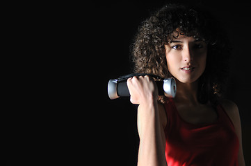 Image showing youg woman workout in fitness club with dumbbell