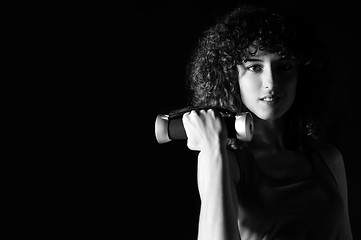 Image showing youg woman workout in fitness club with dumbbell