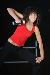 Image showing youg woman workout in fitness club with dumbbell