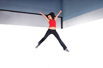 Image showing young woman jumping indoor