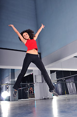 Image showing young woman jumping indoor