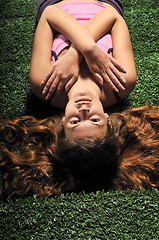 Image showing young woman relax on green stairs with grass surface