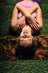 Image showing young woman relax on green stairs with grass surface