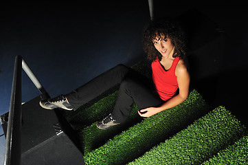 Image showing young woman relax on green stairs with grass surface