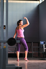 Image showing young woman with strong arms rising hands in air