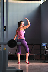 Image showing young woman with strong arms rising hands in air