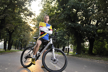 Image showing Fit happy young man smiling on bike