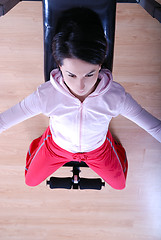 Image showing .a young woman weightlifting at gym 