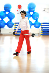 Image showing .a young woman weightlifting at gym 