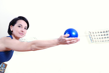 Image showing .happy young woman exercising in a gym