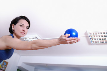 Image showing .happy young woman exercising in a gym