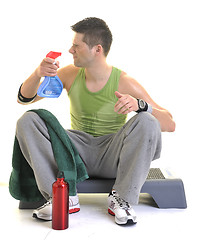 Image showing sportsman relaxing and drinking water