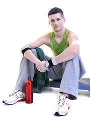 Image showing sportsman relaxing and drinking water