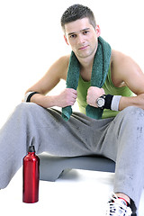 Image showing sportsman relaxing and drinking water