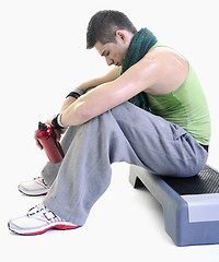 Image showing sportsman relaxing and drinking water