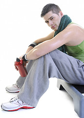 Image showing sportsman relaxing and drinking water