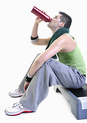 Image showing sportsman relaxing and drinking water
