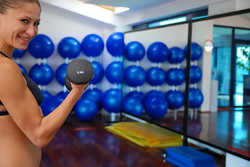 Image showing woman doing exercise with dumbbell