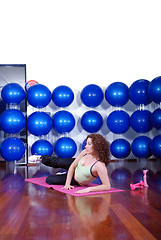 Image showing young pretty woman exercising in a fitness center