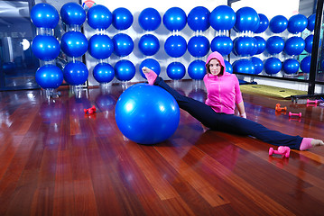 Image showing young pretty woman exercising in a fitness center