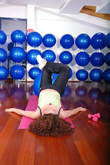 Image showing young pretty woman exercising in a fitness center