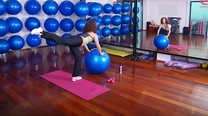 Image showing young pretty woman exercising in a fitness center