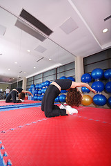 Image showing pretty girl warming up in fitness studio