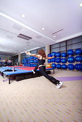 Image showing pretty girl warming up in fitness studio