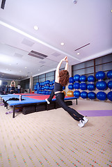 Image showing pretty girl warming up in fitness studio