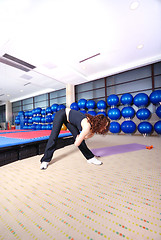 Image showing pretty girl warming up in fitness studio