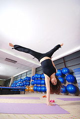 Image showing healthy woman exercising in fitness club