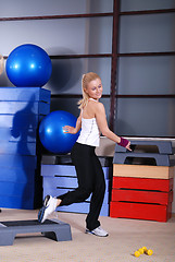 Image showing woman stepping in a fitness center