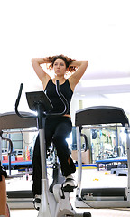 Image showing Women working out on spinning bikes at the gym 