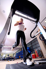 Image showing Girl running on the treadmill in the gym