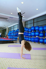 Image showing Pretty girl exercising in a fitness studio