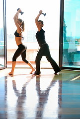 Image showing two girls doing exercise with dumbbells