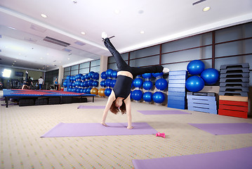 Image showing Pretty girl exercising in a fitness studio
