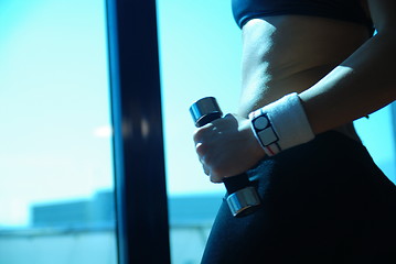 Image showing woman doing exercise with dumbbell