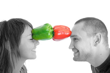 Image showing happy couple holding peppers with head