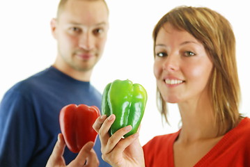 Image showing happy couple with peppers isolated