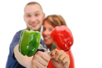 Image showing happy couple with peppers isolated